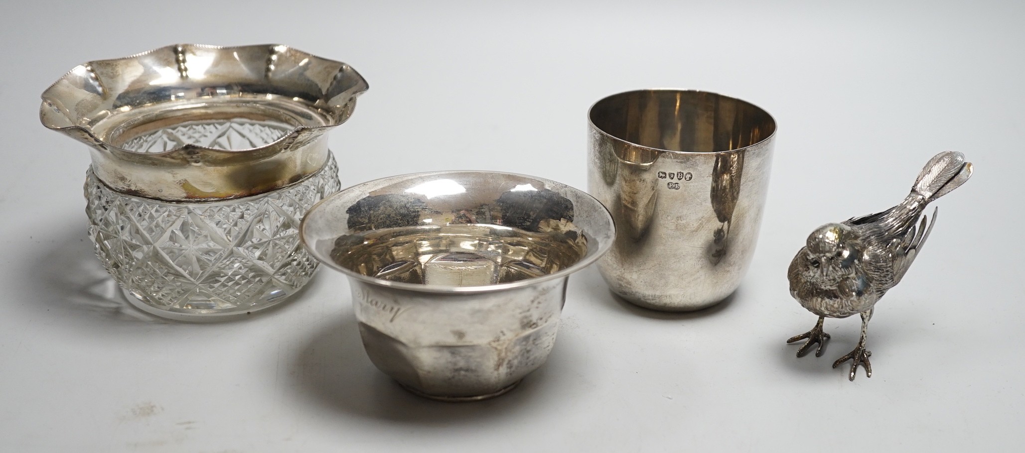 A Victorian silver tumbler cup, by Frederick Elkington, London, 1877, height 72mm, together with a silver mounted glass jar (lacking cover), a small silver bowl and an 800 white metal free-standing miniature model of a b